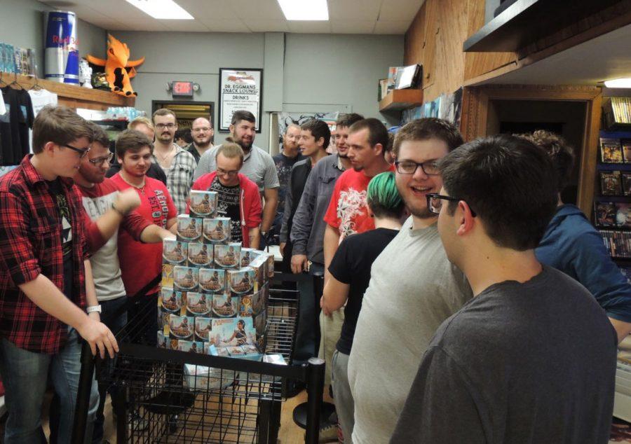 Gamers gather around prerelease boxes, waiting to get their cards at midnight Friday at The Gaming Goat, 229 E. Lincoln Highway.