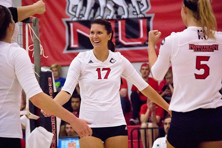 Redshirt senior middle blocker Lauren Zielinski (middle) celebrates a point during a game against Bowling Green State University Saturday.