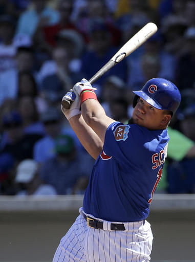 Chicago Cubs' Kyle Schwarber bats against the Milwaukee Brewers during a spring training baseball game March 25 in Mesa, Arizona. Schwarber has been added to the Chicago Cubs' World Series roster and could start Tuesday night's opener against the Cleveland Indians at designated hitter.