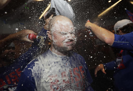 Chicago Cubs Jon Lester is doused as players celebrate after Game 6 of the National League baseball championship series against the Los Angeles Dodgers, today in Chicago. The Cubs won 5-0 to win the series and advance to the World Series against the Cleveland Indians.