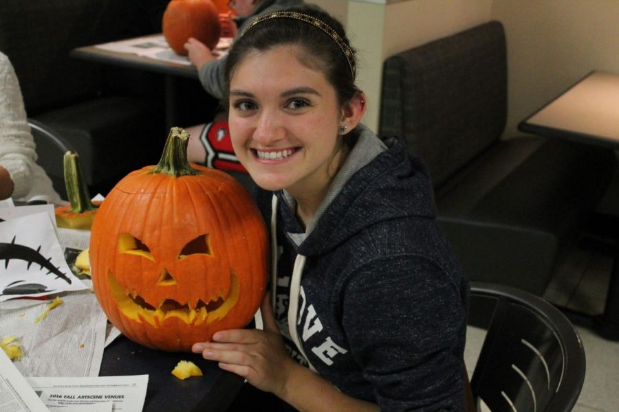 Senior statistics major Jessica Bishop shows off her pumpkin proudly. She said she loves to carve pumpkins, even though it can be messy at times. The pumpkin carving was held 6 p.m. Thursday at the Holmes Student Center near the College Grind. 