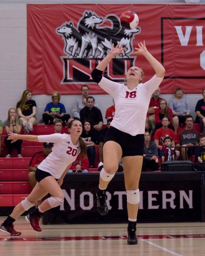 Sophomore middle blocker Wolowicz sets a ball for teammate senior outside hitter Mary Grace Kelly during a match against Bowling Green State University on Sept. 24 at Victor E. Court.