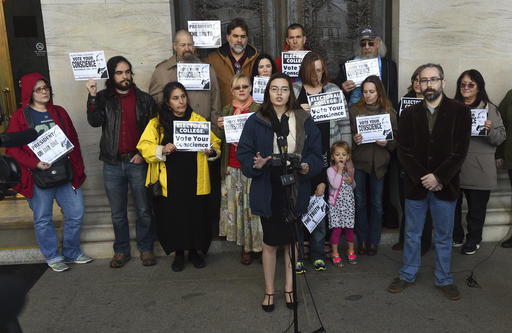 Washington state presidential elector Levi Guerra, center, announces that shes asking members of the Electoral College to pick a Republican consensus candidate rather than Donald Trump during a news conference in front of the Legislative Building, 416 Sid Snyder Ave., Wednesday in Olympia, Wash.