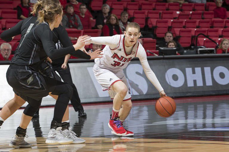 Senior guard Ally Lehman drives the ball to the lane against two Akron University defenders in a Jan. 18 game at the Convocation Center. The Huskies lost the game 55-84.