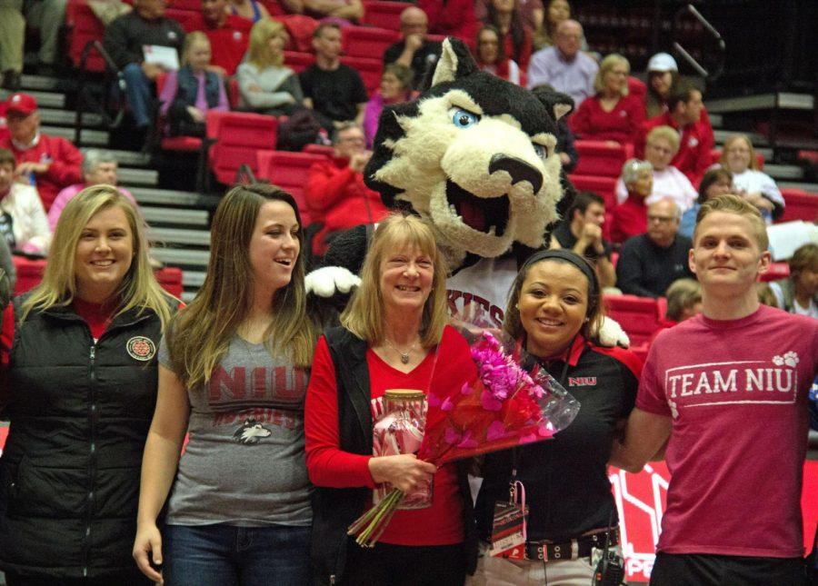 In the forth quarter of the womens basketball game Friday at the convocation center, a group of New Hall residents present Barb Meredith with flowers and a vase.
