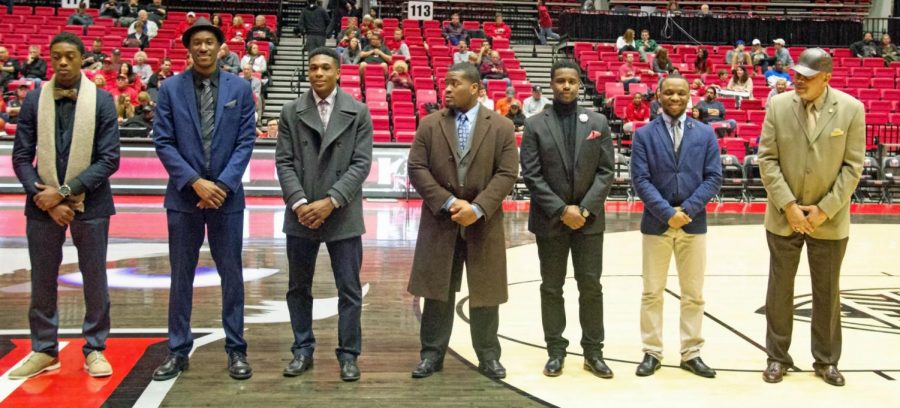 Members of BMI stand while being recognized for Black History Month during a Feb. 28 men’s basketball game at the Convocation Center. BMI will be hosting their annual Apollo Talent Show 6:30 p.m. Friday at the Carl Sandburg Auditorium.