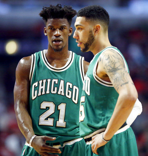 Chicago Bulls guard and forward Jimmy Butler, left, talks with guard Denzel Valentine during the first half of an NBA basketball game against the Memphis Grizzlies Wednesday in Chicago.