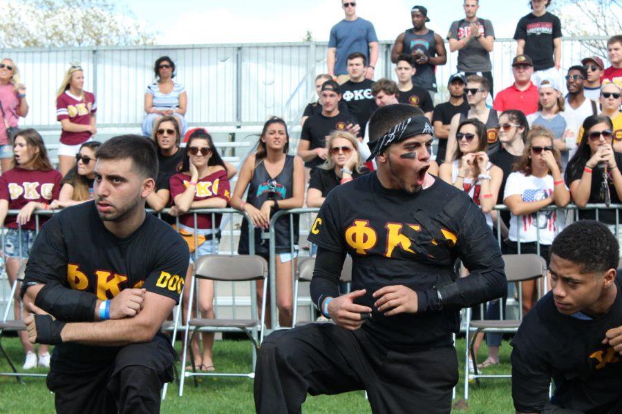 Antonio Rosado (middle) of Phi Kappa Theta cheers on his team members against Alpha Kappa Lambda as Nicholas Mufarreh (left) and Javon Thompson (right) pay close attention to the other team on Monday.
