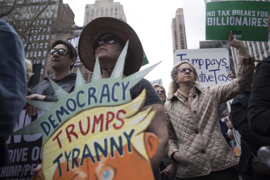 Demonstrators participate in a march and rally to demand President Donald Trump release his tax returns, Saturday, April 15, 2017, in New York. Protesters took to the streets in dozens of cities nationwide Saturday to call on President Donald Trump to release his tax returns, saying Americans deserve to know about his business ties and potential conflicts of interest. (AP Photo/Mary Altaffer)