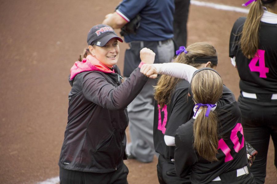 Head Coach Christina Sutcliffe and sophomore outfielder Katie Lamich celebrate during the last home game Saturday against Easter Michigan where the Huskies won 5-3.