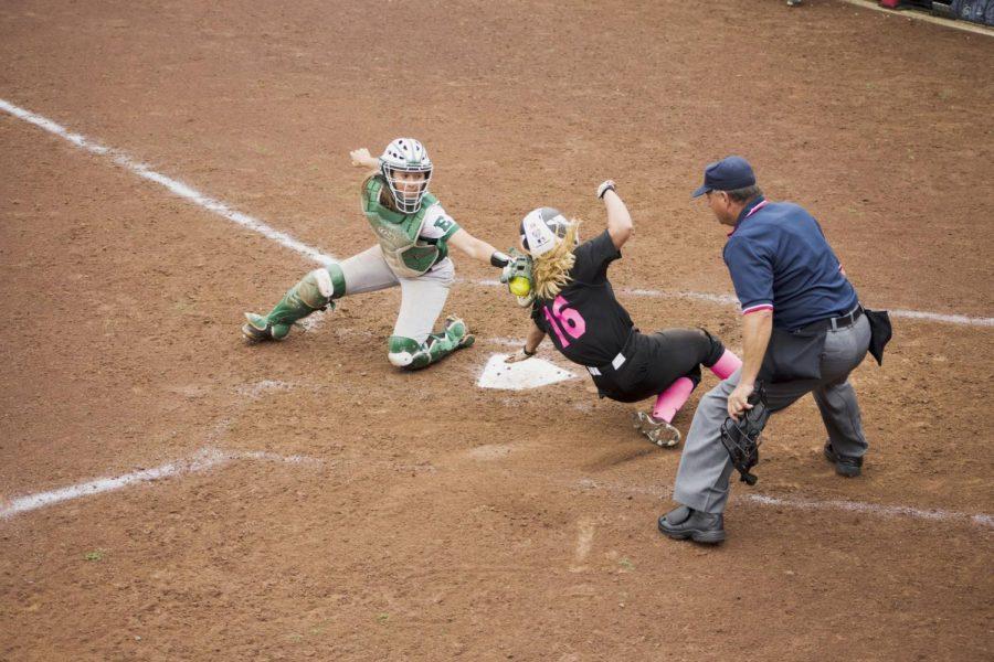 Sophomore outfielder Jessica Rio slides into home plate against Eastern Michigan April 28. The Huskies beat the Eagles in three games. 