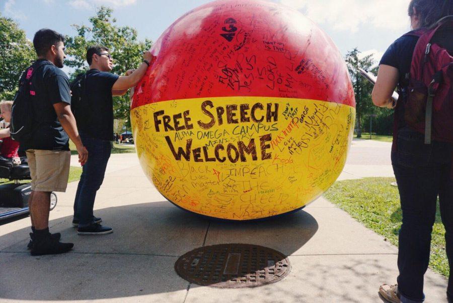 Students+sign+a+%E2%80%9Cfree+speech+ball%2C%E2%80%9D+which+was+rolled+around+campus+by+student+organization+Turning+Point+USA+Wednesday+in+MLK+Commons.