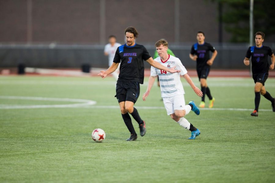 Junior forward Noah Brodie (right) attempts to steal the ball from the DePaul player. The Huskies won 3-2 in overtime.