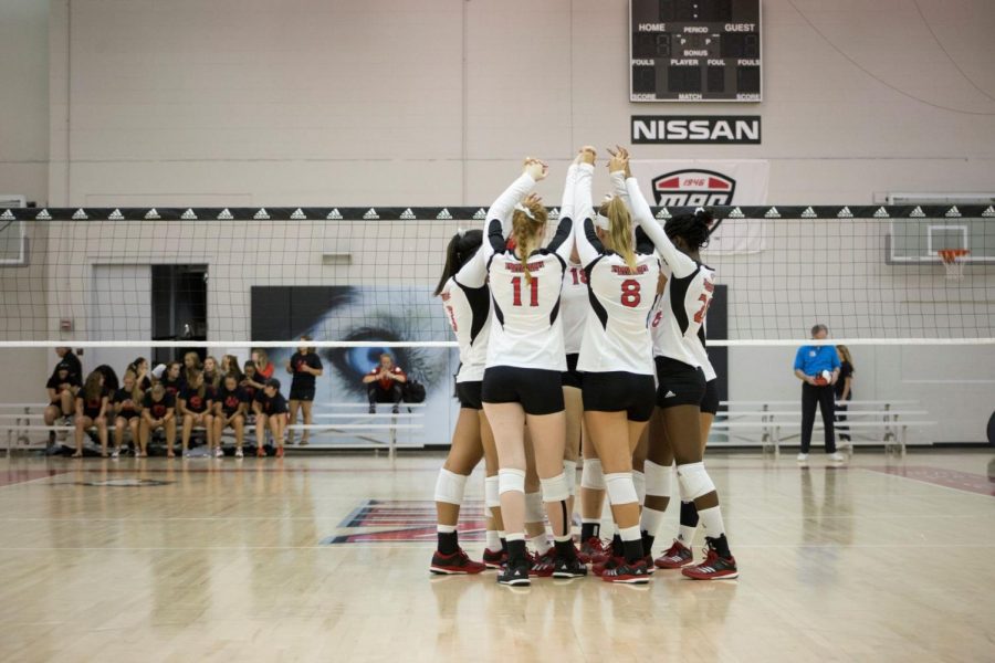 The volleyball team comes together during Friday’s game against High Point. The Huskies lost the game 3-1. 