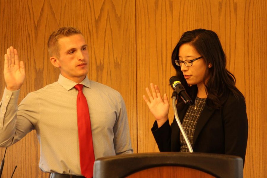 Student Association Senate speaker, Christine Wang, swears in Matthew Moore as a new senator. 