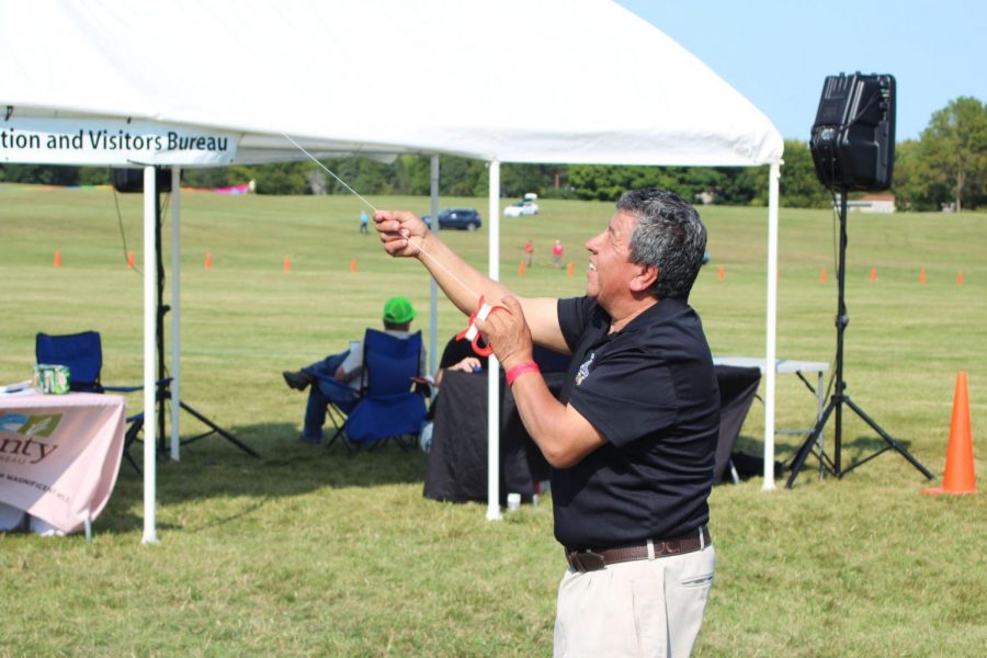 DeKalb resident, Jose Rosas, participates in the fun by testing out a kite in the sky at Kite Fest on Sunday.