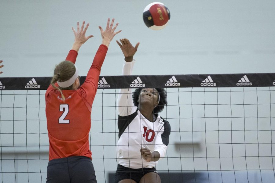 Redshirt junior middle blocker Chrystal McAlpin hits the ball over the net in their game against Western Kentucky Saturday. The Huskies lost the match in three sets (25-12, 25-20, 25-18).