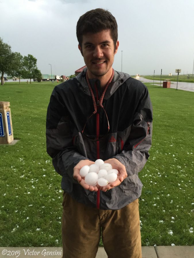 Atmospheric science professor Victor Gensini holds a handful of hail near Dwyer, Wyo. Gensini, who joined the faculty in August, is known for his research regarding the prediction of tornadoes.