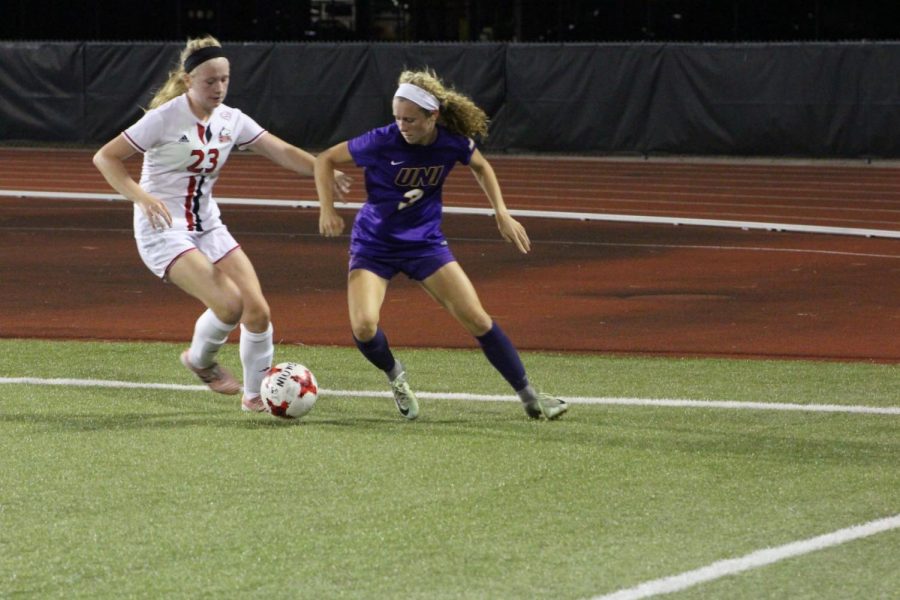 Sophomore defender Jennie Nailor (left) dribbles against the Northern Iowa defender Friday at home. The Huskies lost the game 3-2. 