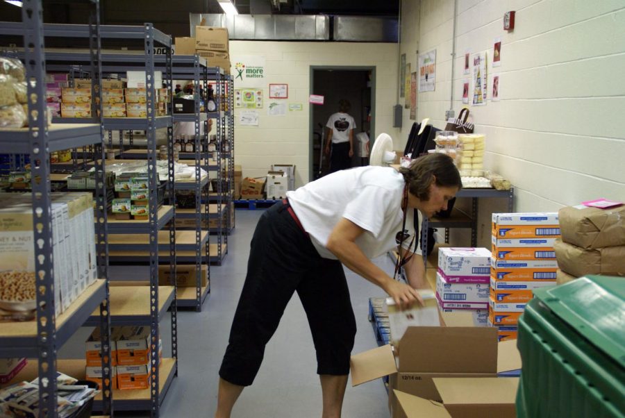 Becky Mascal, of DeKalb, organizes donated goods at the Barb Food Mart in Huntley Middle School in DeKalb. The Barb Food Mart, which is partnered with the Northern Illinois Food Bank, is open from 4:30 to 6 p.m. every Thursday.
