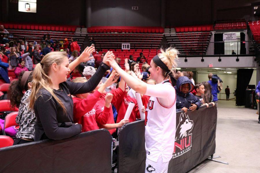Junior guard Courtney Woods greets the fans after the Huskies’ 80-71 home win Wednesday against Loyola University Chicago. The Huskies are 6-2 on the season.