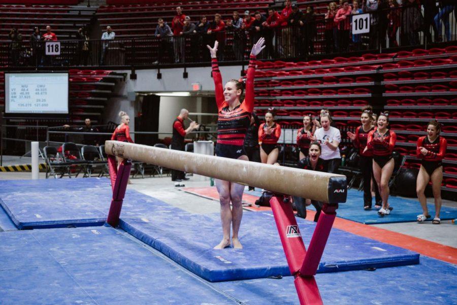 Senior gymnast Ashley Potts finishes her balance beam exercise in the Huskies’ home loss Jan. 28 to Central Michigan.