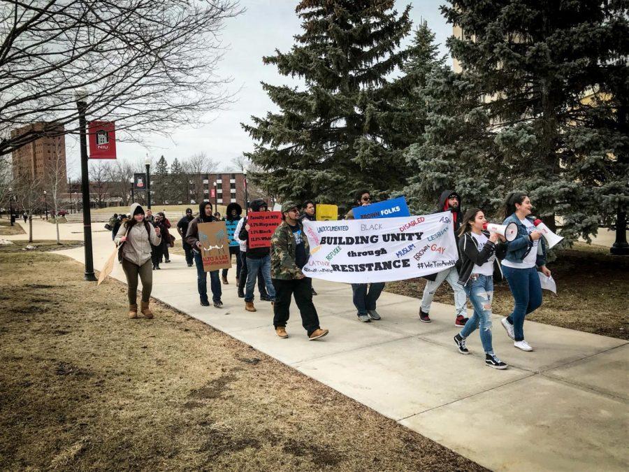 Members of the Latino Student Alliance and DREAM Action NIU march from MLK Commons toward Wirtz Hall Thursday. 
