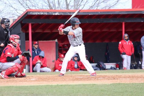 Sophomore catcher Jake Dunham awaits a pitch in the Huskies’ 10-5 home win April 10 against the University of Illinois-Chicago Flames.
