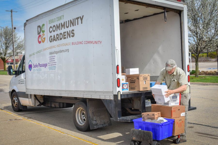 Dan Kenney, executive director and founder of DCCG, unpacks  Grow Mobile food pantry donations for citizens of DeKalb.