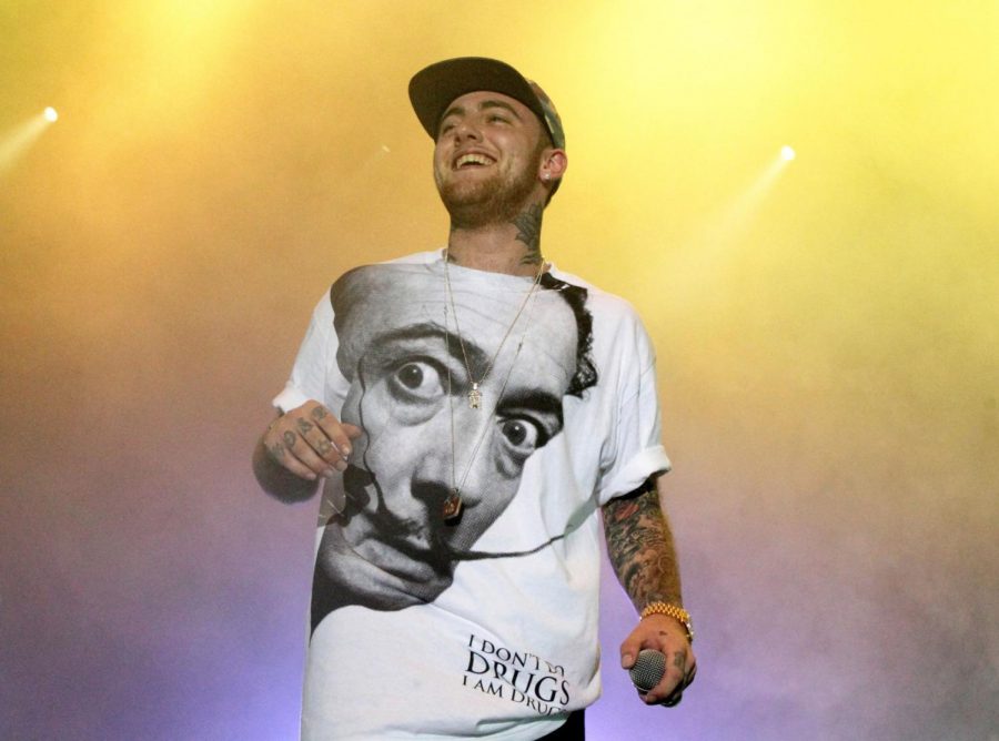 FILE - In this July 13, 2013, file photo, Rapper Mac Miller performs on his Space Migration Tour at Festival Pier in Philadelphia. Ariana Grande has posted a tribute to her ex-boyfriend Mac Miller a week after his death, saying she’s sorry she couldn’t save him. Paramedics declared the 26-year-old Miller dead in his Los Angeles home Sept. 7. (Photo by Owen Sweeney/Invision/AP, File)
