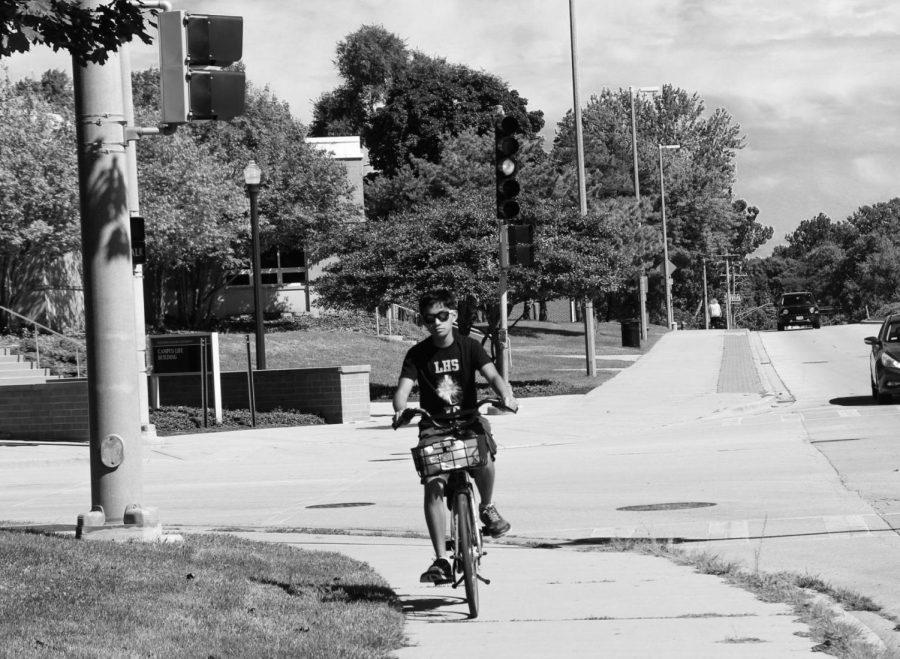 Freshman biology major, Diego Reyes travels through campus on one of the many picturesque bike routes located on and around NIU campus.