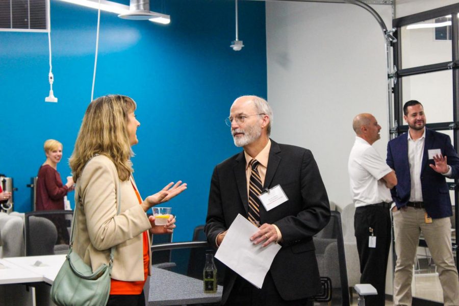 Gerald Blazey, vice president for research and innovation partnership, speaks with Discover Director Jennifer Joseph during the code_orange program grand opening.