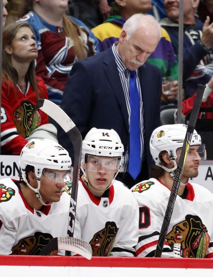 FILE - In this March 30, 2018, file photo, Chicago Blackhawks head coach Joel Quenneville, back, looks down after his team gave up a power-play goal against the Colorado Avalanche inthe second period of an NHL hockey game in Denver. The Blackhawks have fired three-time Stanley Cup winning coach Joel Quenneville on Tuesday, Nov. 6, 2018.(AP Photo/David Zalubowski, File)