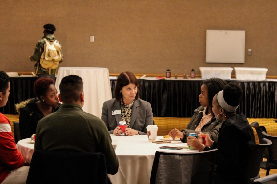 NIU President Lisa Freeman sits with students to get acquainted with them Monday during Pizza with the Presidents in the Holmes Student Center.