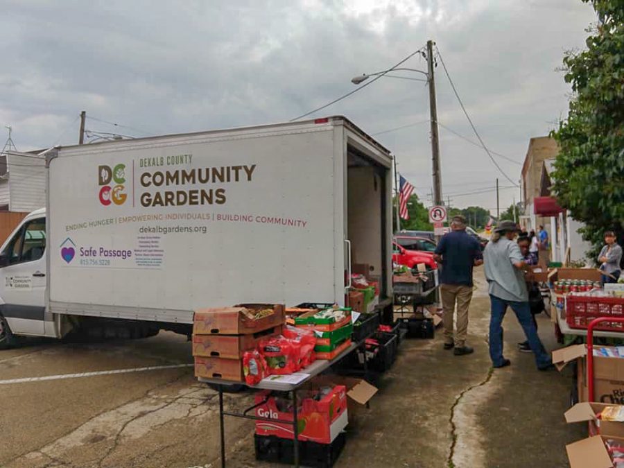 Dan Kenney, executive director of DeKalb County Community Gardens, (left) sets up a Grow Mobile food distribution in Kingston with  Christy Westman, Grow Mobile Program coordinator in 2019.