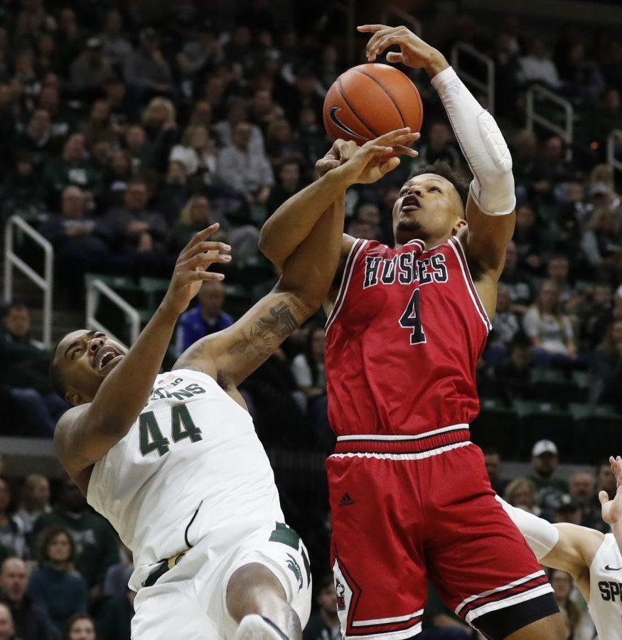 Michigan State forward Nick Ward (44) and Northern Illinois forward Lacey James (4) fight for the rebound during the first half of an NCAA college basketball game, Saturday, Dec. 29, 2018, in East Lansing, Mich. (AP Photo/Carlos Osorio)