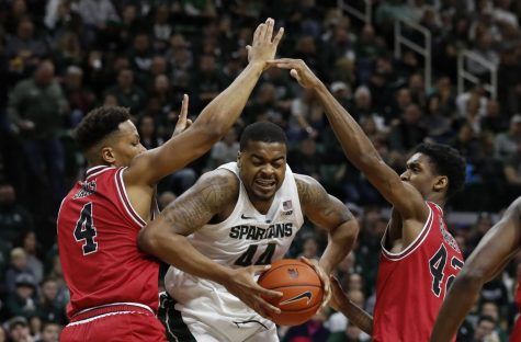 Michigan State forward Nick Ward (44) is double teamed by Northern Illinois forwards Lacey James (4) and Levi Bradley (42) during the second half of an NCAA college basketball game, Saturday, Dec. 29, 2018, in East Lansing, Mich. (AP Photo/Carlos Osorio)