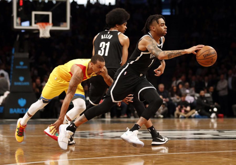 Brooklyn Nets guard D'Angelo Russell, right, drives past Milwaukee Bucks guard George Hill, left, during the first half of an NBA basketball game, Monday, April 1, 2019, in New York.