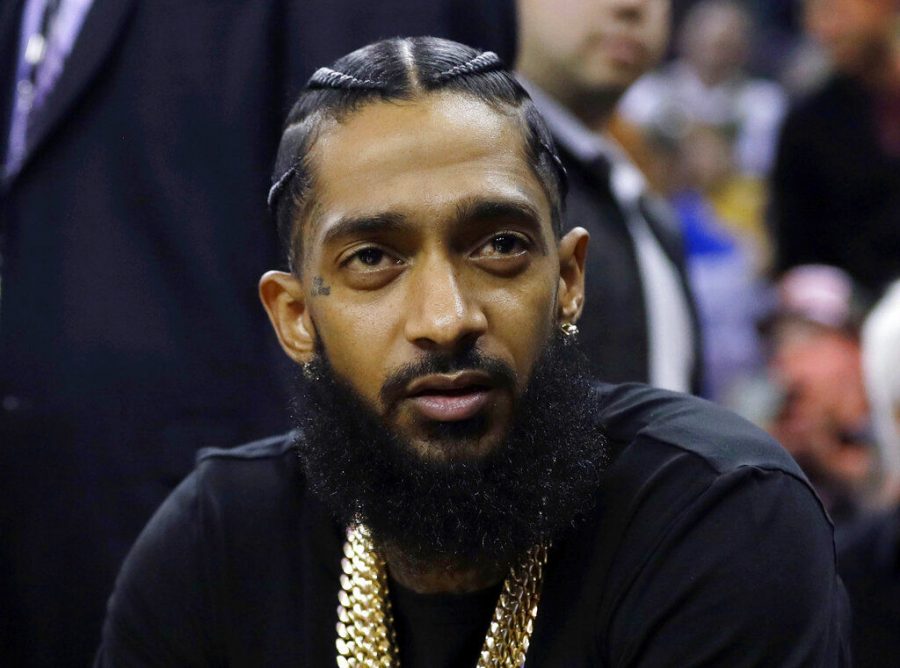 Rapper Nipsey Hussle sits at an NBA basketball game March 29, 2018. Hussle was shot and killed March 31 outside his clothing store after a confrontation with Eric Holder.