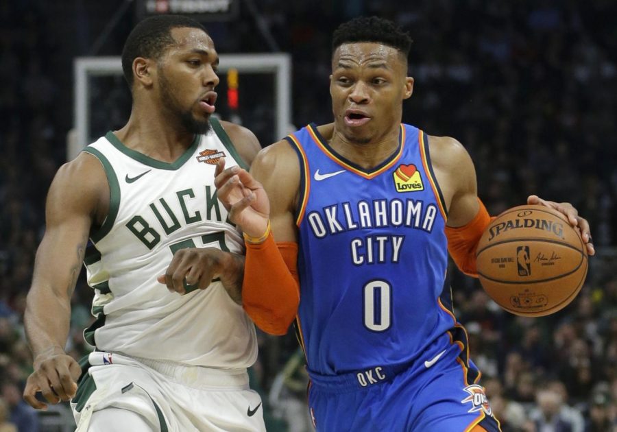 Oklahoma City Thunder's Russell Westbrook drives to the basket against Milwaukee Bucks' Sterling Brown during the first half of an NBA basketball game Wednesday, April 10, 2019, in Milwaukee. 