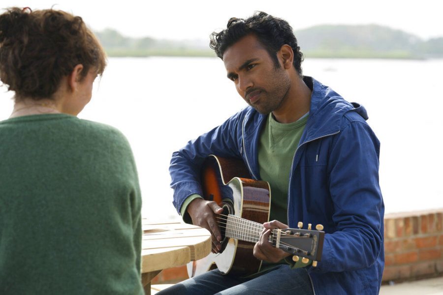 (right) Jack Malik, played by Himesh Patel, serenades Ellie, played by Lily James, in Yesterday with the titular song by The Beatles.