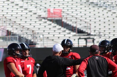 Offensive coordinator Eric Eidsness addresses the quarterbacks during practice Wednesday at Huskie Stadium.