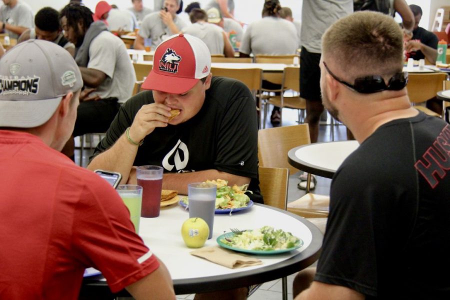 Logan Nielsen, junior sports management major, eats lunch Aug. 6 with his friends at New Hall Dining.