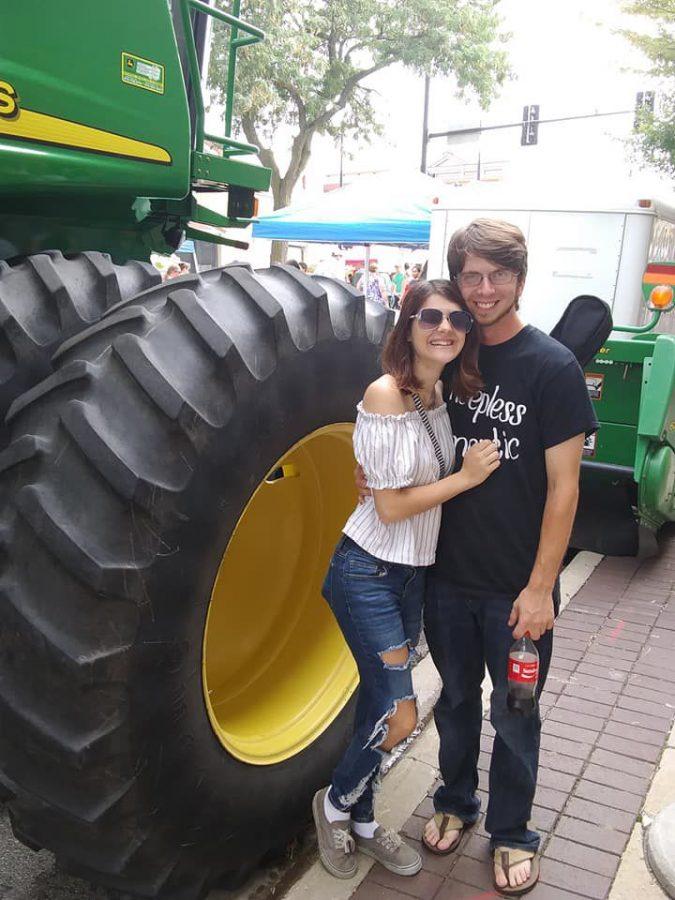 Editor in Chief Sam Malone (left) and Zack Edwards, Chicago Ridge, stand in front of a tractor at the 2018 Corn Fest