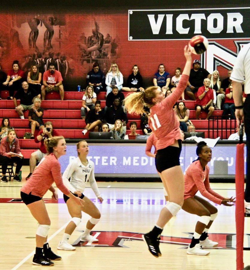 Senior middle blocker Brinley Milbrath goes up Aug. 30 for a swing in a match against Southern Illinois University - Edwardsville in an eventual 3-1 loss to the Cougars at Victor E. Court at the Convocation Center in Dekalb.