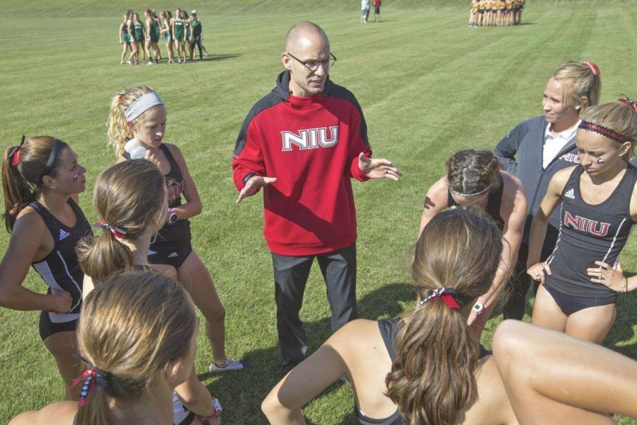 NIU cross country Head Coach Adrian Myers talks to his team in 2019.