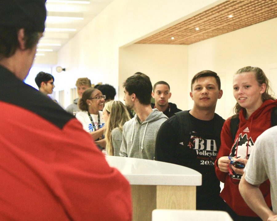 Tevion Albert, first-year pre-physcial therapy major (from left), Chris Babicz first-year accounting major and Kellyanne Critzer first-year elementary education major wait in a long line of students Tuesday at New Hall Dining. 