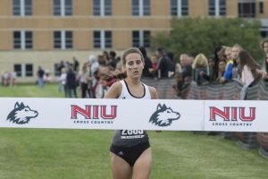 Junior runner Ashley Tutt approaches the finish line to take first place Sept. 11 at the Huskie Challenge.