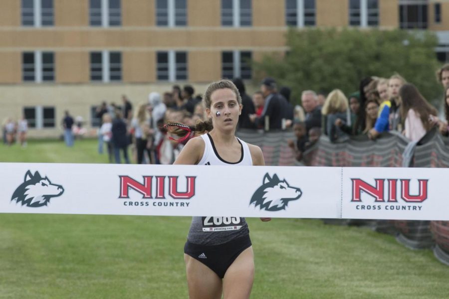 Junior runner Ashley Tutt approaches the finish line to take first place Sept. 11 at the Huskie Challenge.