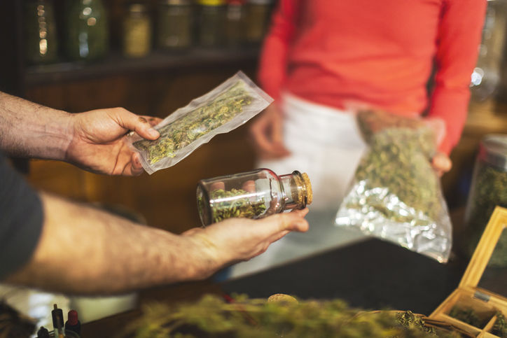 Adult Man Buying Cannabis Buds at Small Cannabis Store.